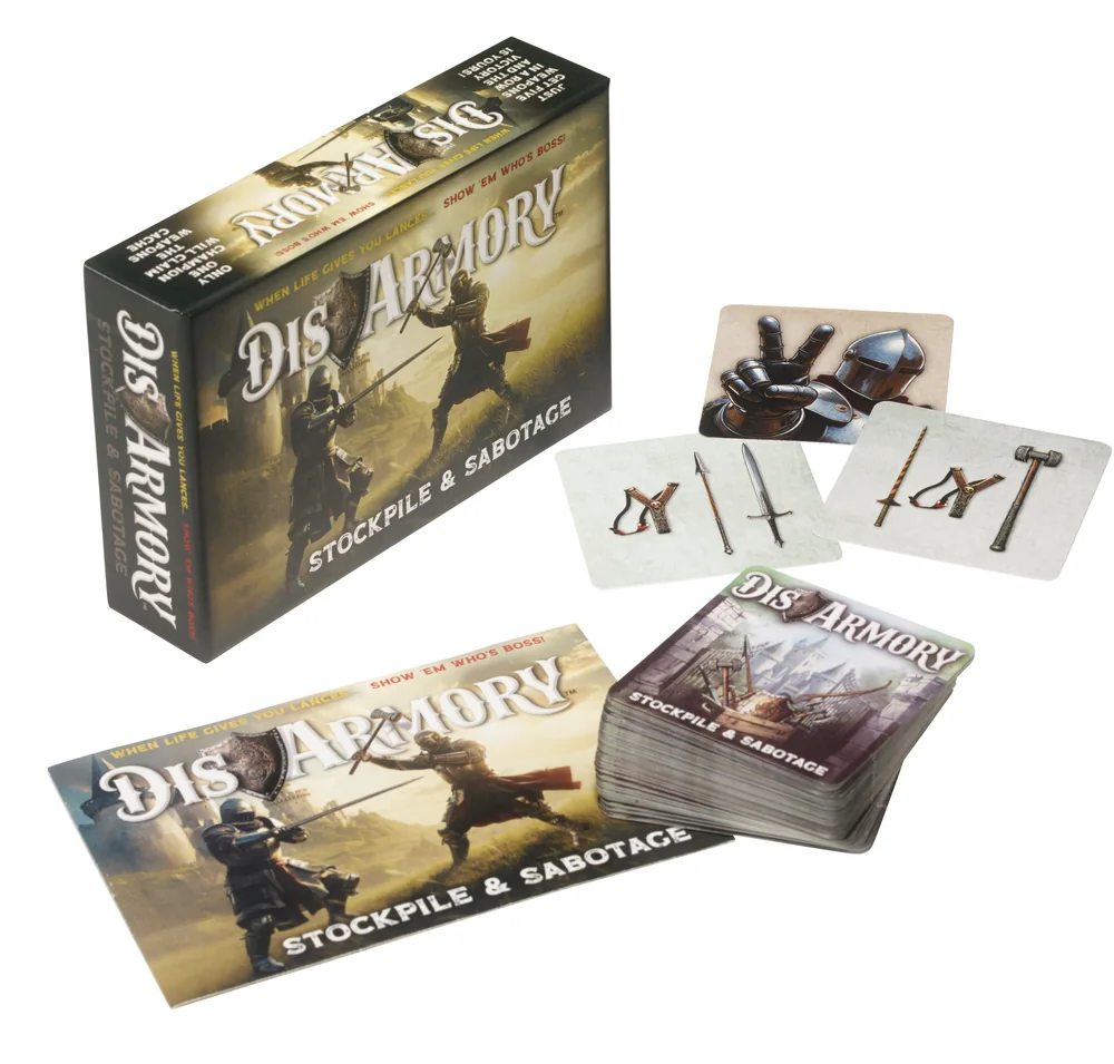 A spread of illustrated DisArmory weapon cards fanned around the rule book